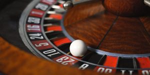 close up view of a roulette and a white ball on slot 23 red